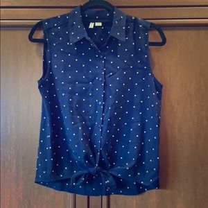 Sleeveless navy and white polka dot button down